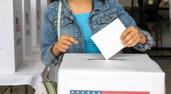 Female dropping ballot into voting ballot box