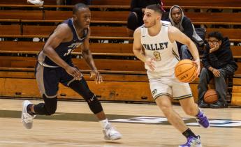 Men's Basketball player dribbling the basketball