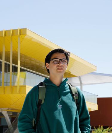 Student in Front of Campus Building
